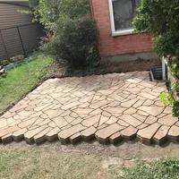 Flagstone patio laid against a garden bed